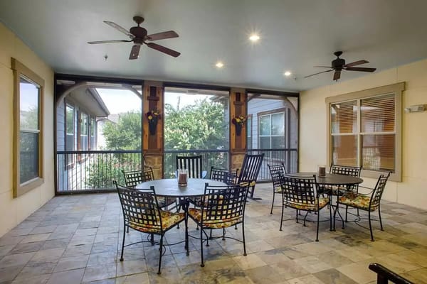 Outdoor lounge area with seating and fans