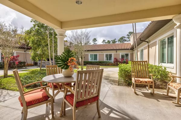 Outdoor patio with seating and greenery at Discovery Village