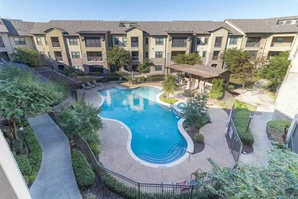 Aerial view of a pool area surrounded by buildings