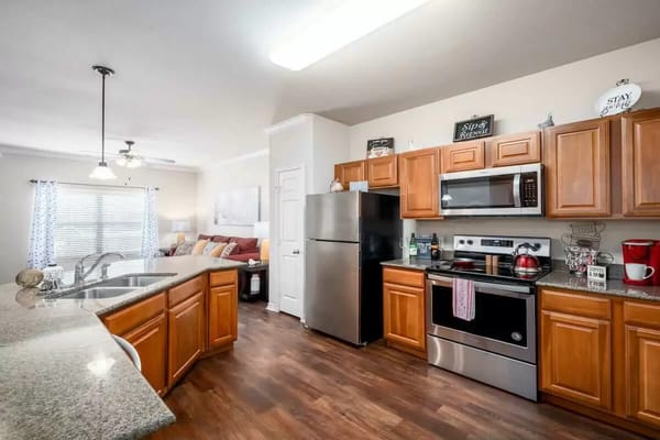 Bright kitchen area with modern appliances and furnishings