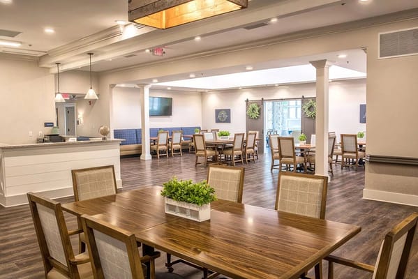 Bright dining area with wooden tables and chairs
