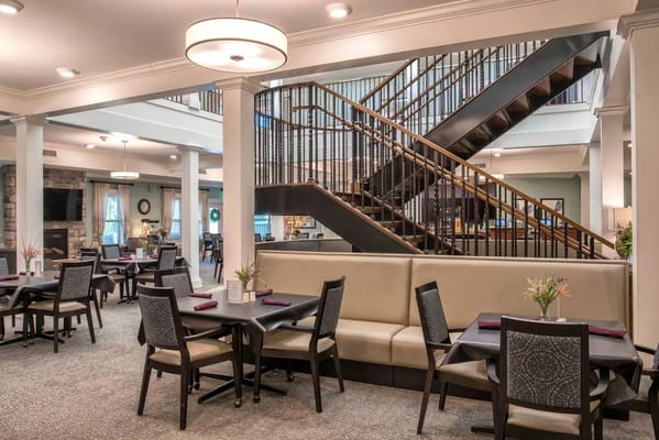 Cozy dining area with tables and a staircase