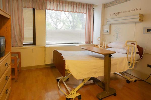 Private resident room with a hospital bed and amenities