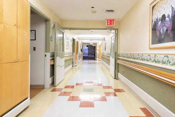 Bright hallway in a nursing facility with artwork