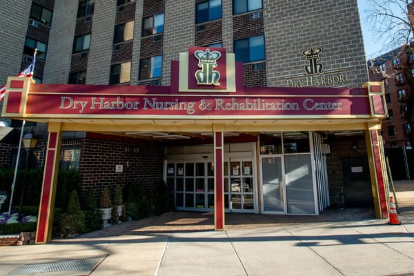 Exterior view of Dry Harbor Nursing & Rehabilitation Center entrance