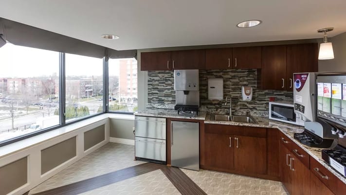 Bright kitchen area with modern appliances and large windows