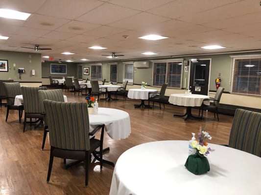 Dining area with tables and chairs set up for residents