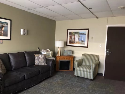 A cozy lounge area with seating and artworks