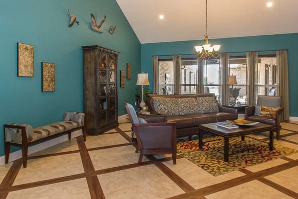 Cozy living room with teal walls and comfortable seating at Echelon Place
