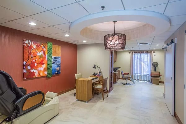 Bright interior of a spa area with a massage chair and decor