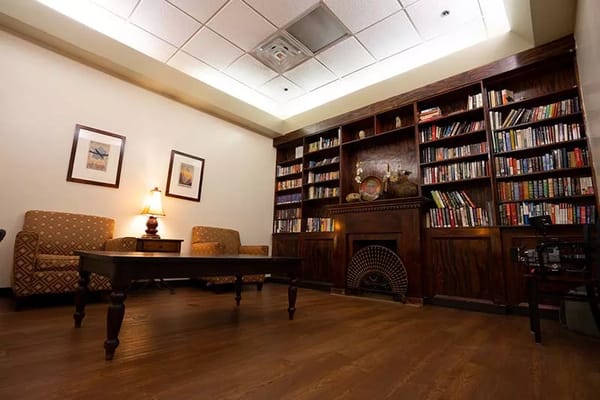 Cozy library area with bookshelves and seating