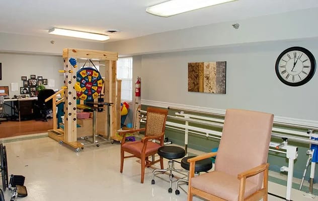Therapy room featuring a colorful spinning wheel and seating