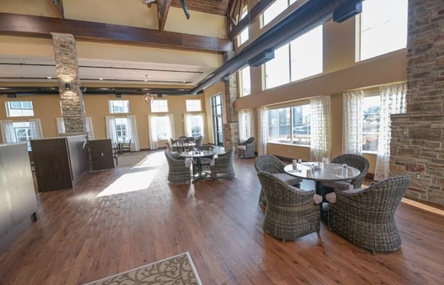 Bright dining area with wooden floors and large windows
