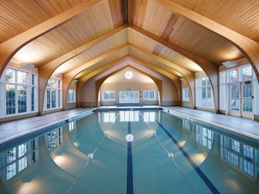 Indoor swimming pool area with wooden architecture