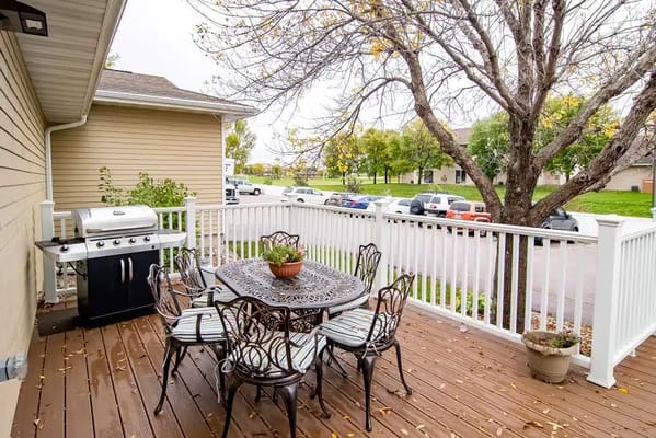 Outdoor patio with a grill and seating area