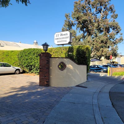 Entrance sign of El Monte Convalescent Hospital with landscaped surroundings
