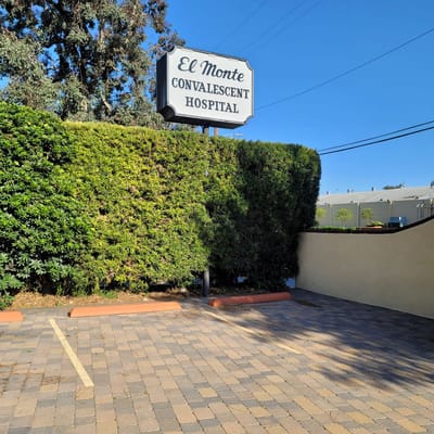 Sign for El Monte Convalescent Hospital surrounded by greenery