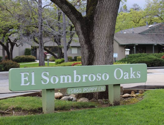 Signage for El Sombroso Oaks with greenery