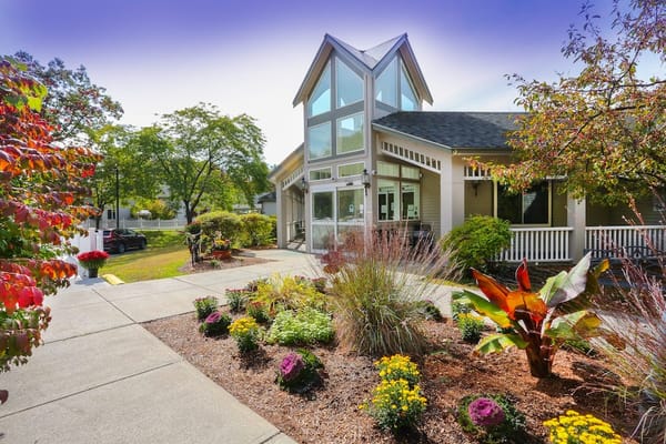 Exterior view of a senior living facility with landscaped garden