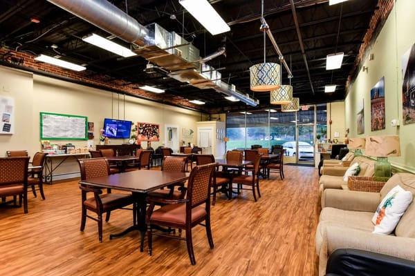 Common area with tables and seating in a warm setting