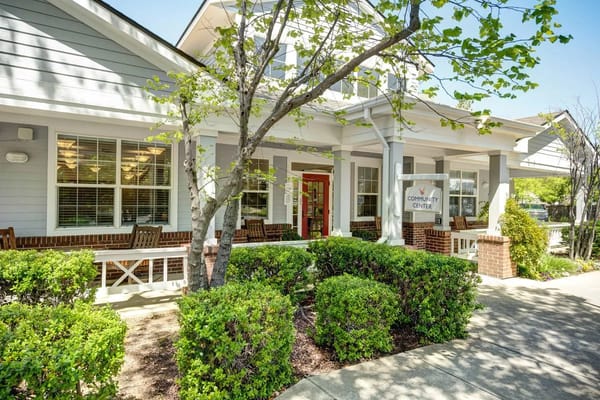 Exterior view of a senior living facility with greenery
