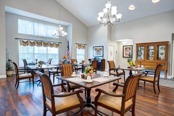 Interior view of a bright dining room with tables and chairs