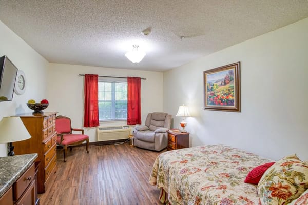 Cozy resident room with floral bedding and art