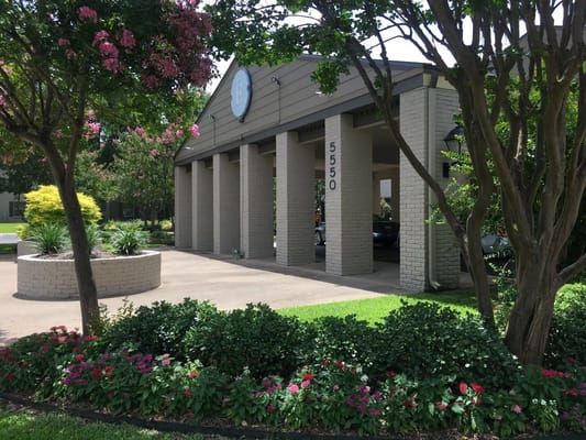 Entrance area with brick columns and flowering plants at Emerson on Harvest Hill