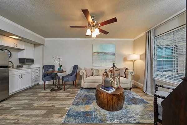 Cozy living room featuring a sofa, dining area, and modern decor
