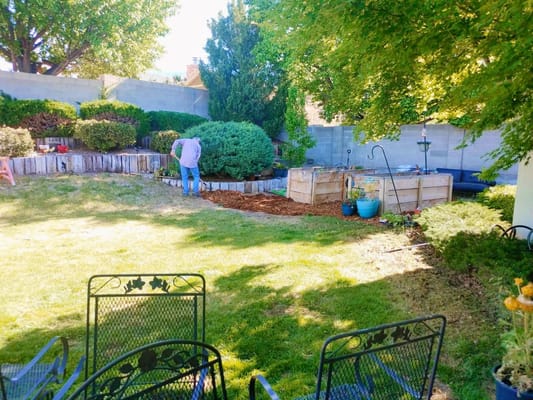 Resident tending to a garden in the facility's outdoor space