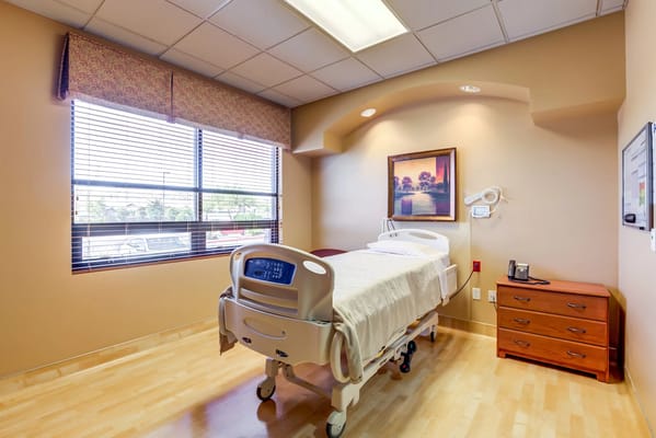 Private resident room with hospital bed and window