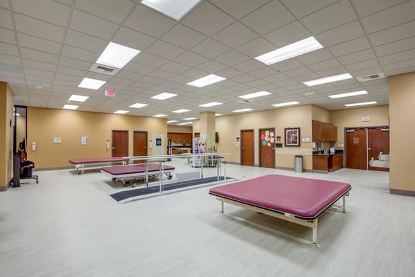 Interior view of a rehabilitation gym with treatment tables