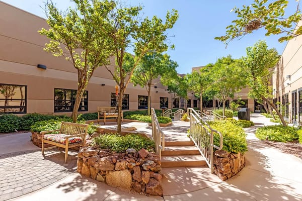 A tranquil outdoor space with seating and greenery
