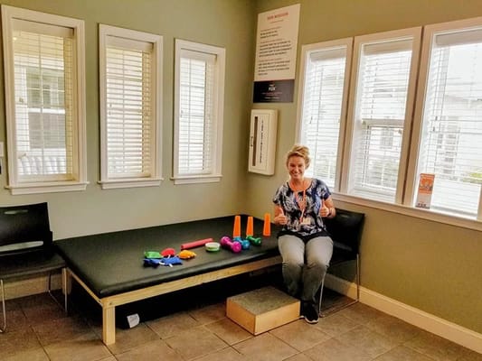 Staff member with therapy tools in an activity room