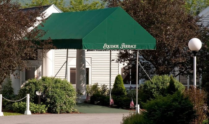 Entrance of Equinox Terrace with green awning
