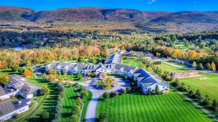Aerial view of Equinox Village surrounded by fall foliage