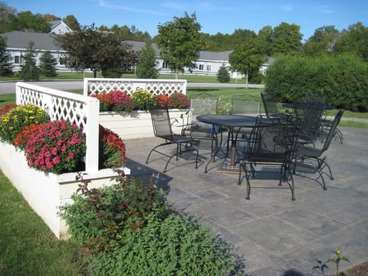 Outdoor patio with seating and flowers