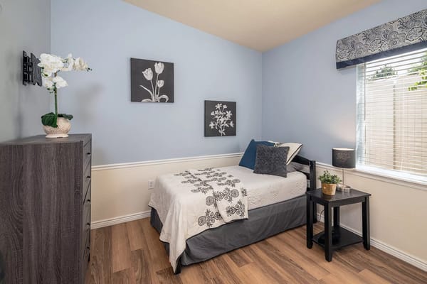 Cozy resident room with floral decor and natural light