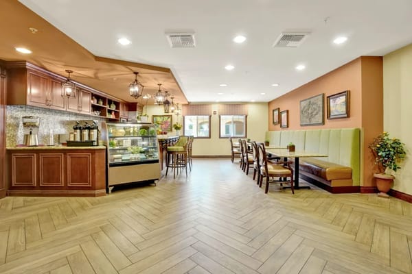 Interior view of the lounge area with seating and beverage station.