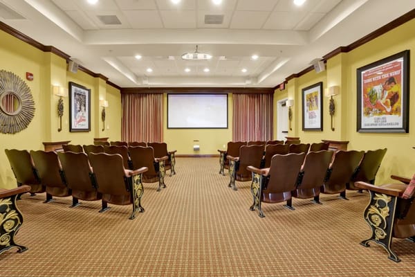 Empty theater room with seating and a large projection screen