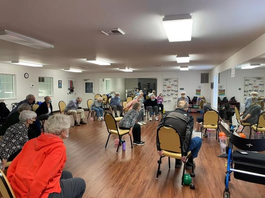 Residents participating in an exercise activity in a spacious room