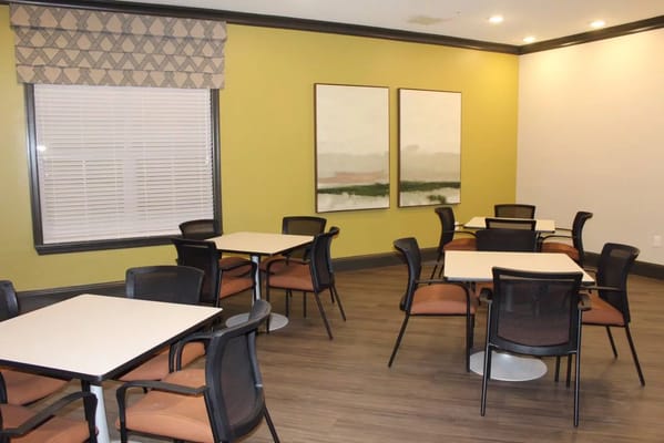 Bright common area with tables and chairs