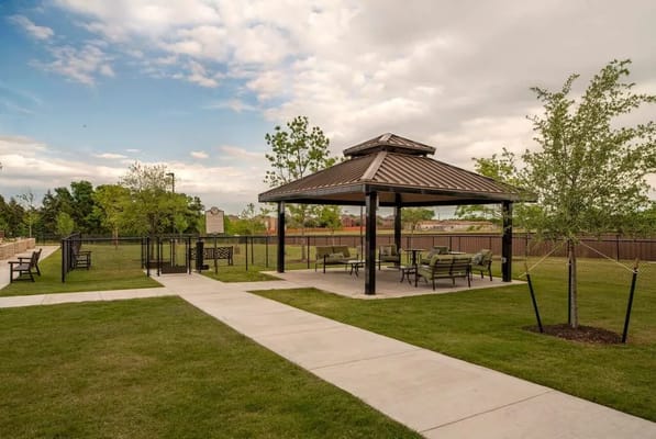 Outdoor gazebo with seating in a green area