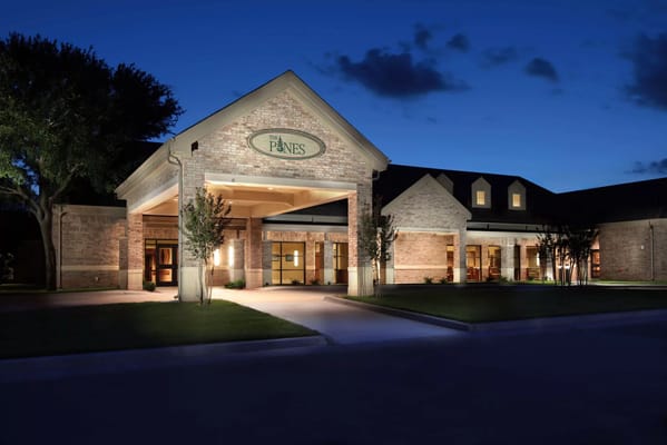 Exterior view of The Gables at Rolling Meadows facility at night