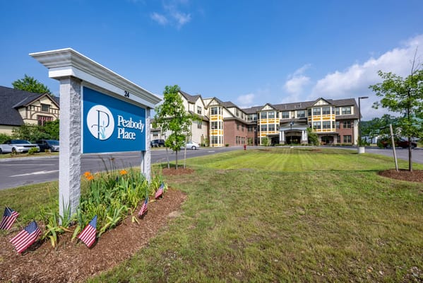 Exterior view of Peabody Place facility with landscaped entrance