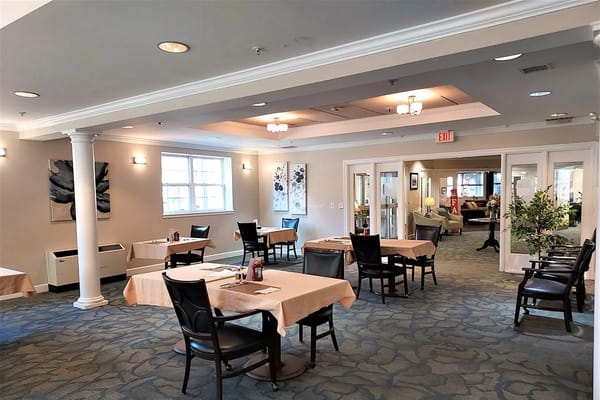 Interior view of dining area with tables and chairs