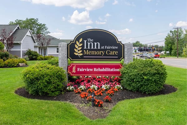 Sign of The Inn at Fairview with flower beds