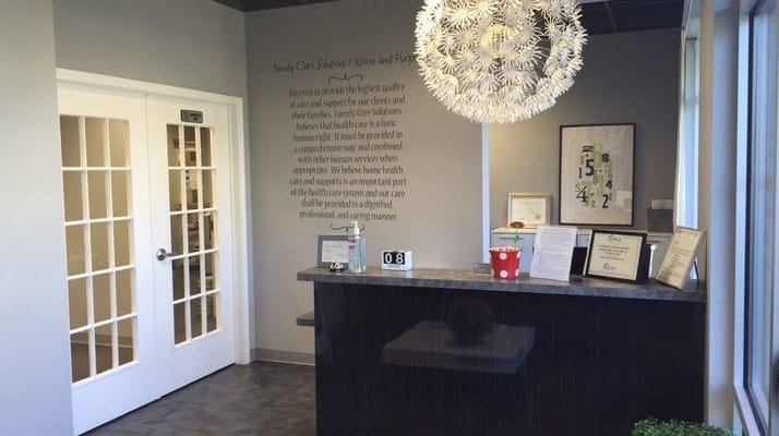 Front desk of Family Care Solutions with decorative lighting and informational displays