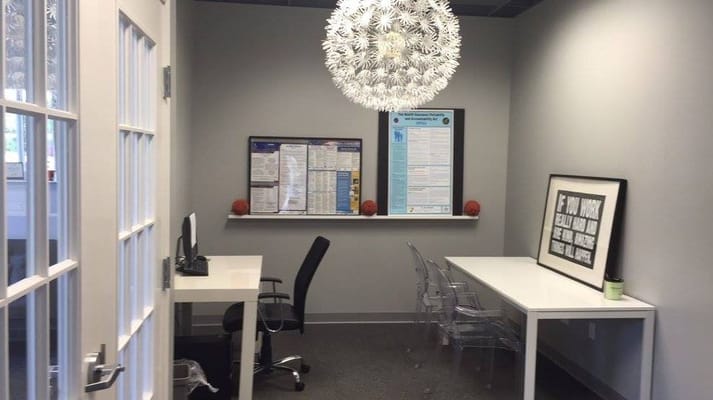 Modern office space with clear chairs and decorative lighting