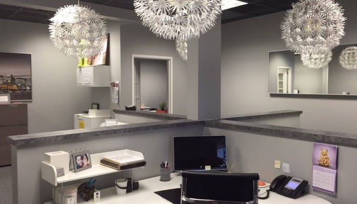 Modern reception desk with decorative lighting at Family Care Solutions